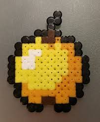 a yellow and black piece of art hanging on a wall in the shape of a sheep