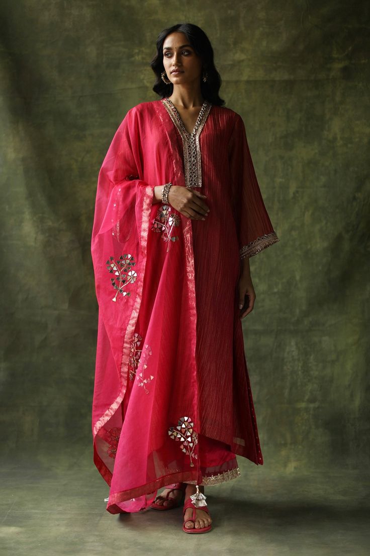 Magenta pink kurta in crinkled silk fabric base and mirror, zari embroidered neckline. Paired with pant, slip and dupatta.
Component: 4
Pattern: Embroidery
Type Of Work: Mirror, zari
Neckline: V neck
Sleeve Type: Long sleeves
Fabric: Kurta: Crinkled Silk, Pant: Modal Satin, Dupatta: Organza
Color: Magenta,Pink
Other Details: 
Tassel bordered dupatta
Golden border
Gota and organza trims
Occasion: Puja - Aza Fashions Blouse Yoke, Embroidered Shirt Dress, Pink Kurta, Silk Kurta, Embroidered Dupatta, Organza Dupatta, Embroidered Neckline, Indian Fashion Designers, Pernia Pop Up Shop