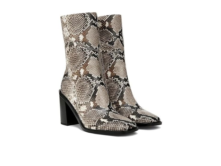 a pair of snakeskin boots with high heel and pointed toe, on a white background