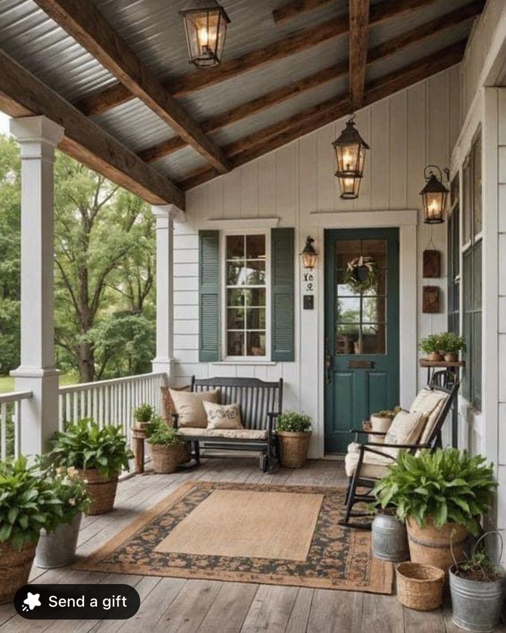 the porch is decorated with potted plants and hanging lanterns on the ceiling, along with two rocking chairs