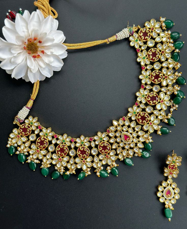 Gorgeous Hyderabadi Gold and green Necklace perfect for any occasion! A very high quality and modern luxurious look for any jewelry lover! This necklace comes with matching earrings that are perfect to wear alone for a lighter look. The colors are very festive and bright enough to sparkle any outfit, yet not overpower the look as the antique gold finish gives real gold look! The necklace is perfect to wear with any saree, lehenga or even style as a indo western look for weddings and occasions. T Dazzling Necklace With Matching Earrings For Gifts, Green Temple Jewelry With Jewels, Dazzling Necklaces With Matching Earrings For Gifts, Green Temple Jewelry For Festive Occasions, Green Temple Jewelry For Celebration, Kundan Necklace For Party With Hand Set Stones, Green Kundan Emerald Necklace For Gift, Green Kundan Necklace For Formal Festivals, Dazzling Kundan Bridal Necklace For Parties