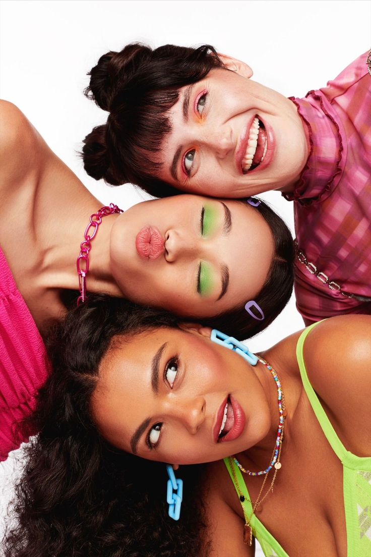 three young women are posing for the camera