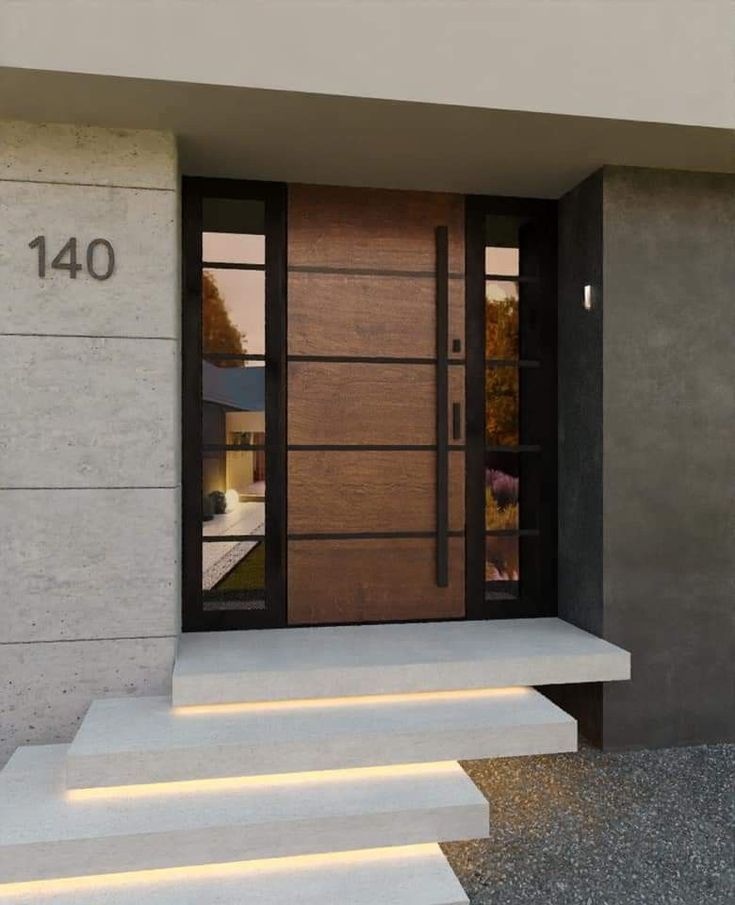 a modern entry way with steps leading up to the front door and glass doors on both sides