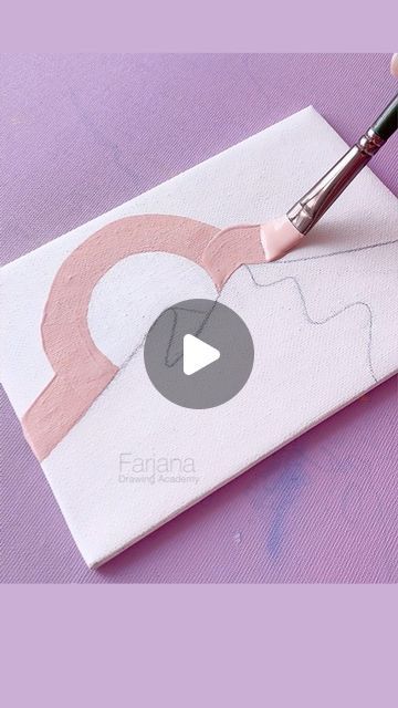 someone is using a brush to paint the design on a piece of paper with pink and white