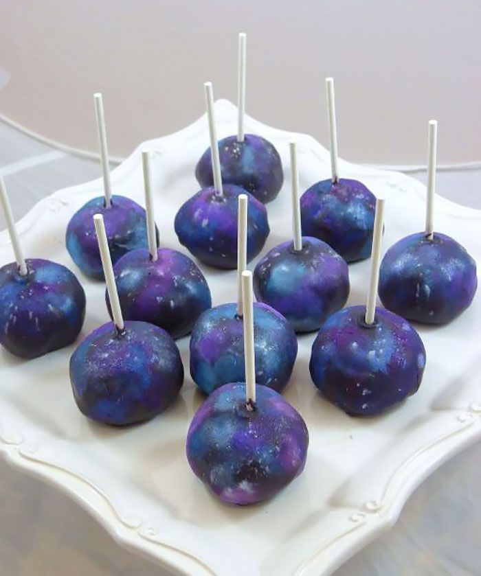 purple and blue cake pops on a white plate