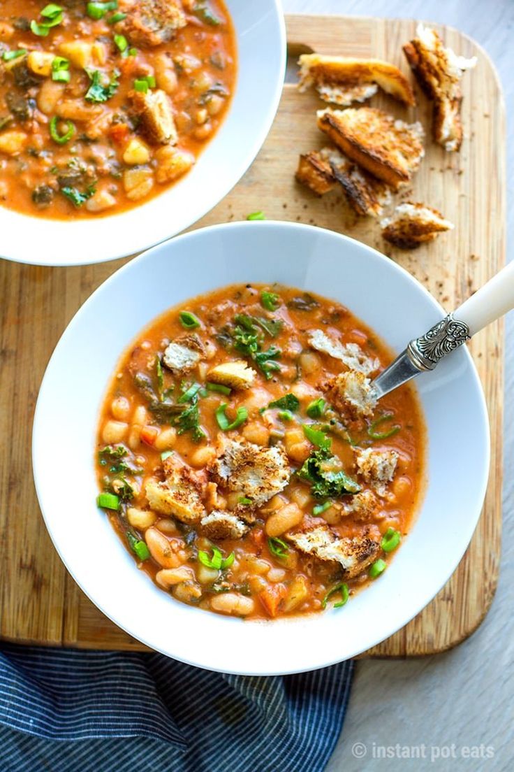 two bowls of soup on a cutting board