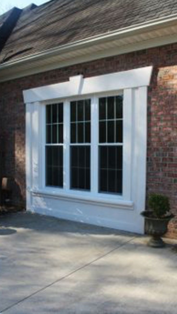 a brick house with white doors and windows