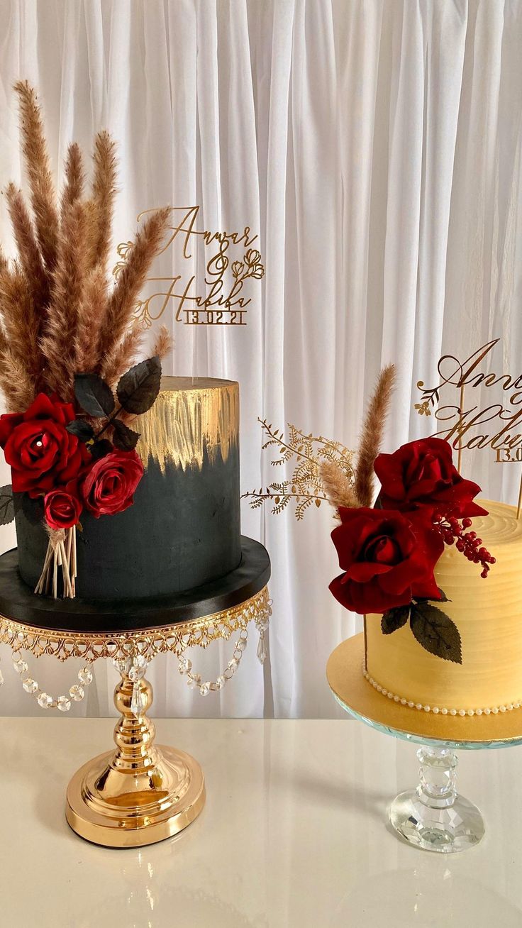 two cakes decorated with flowers and feathers on top of a table next to each other