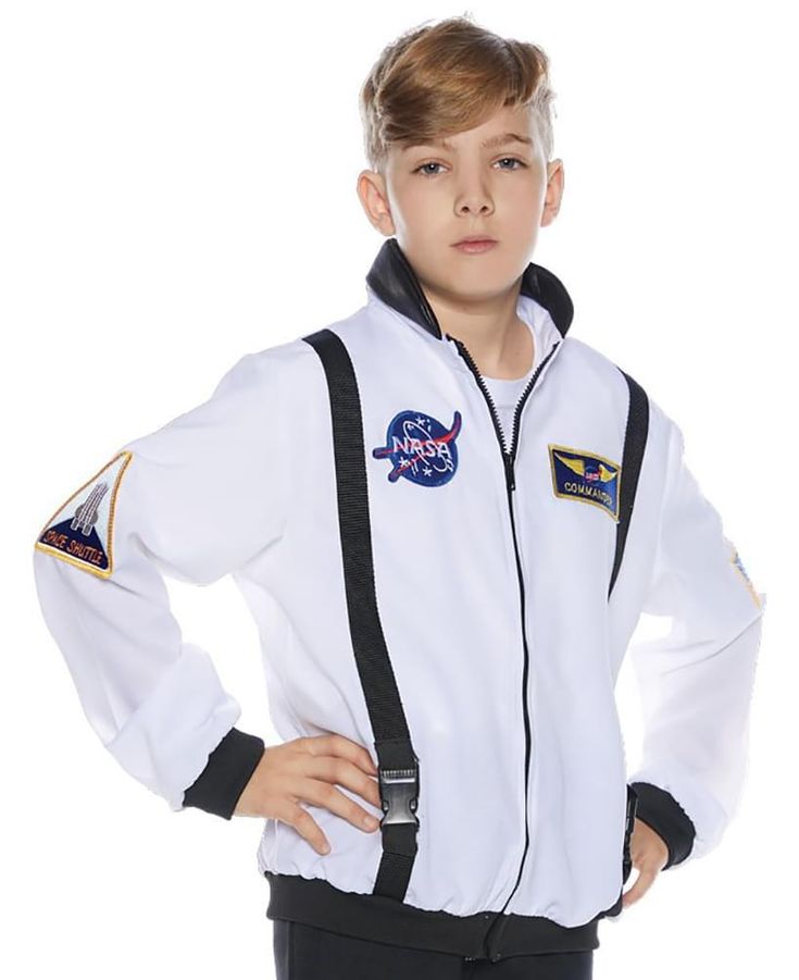 a young boy wearing a white jacket and black pants with nasa patches on the sleeves