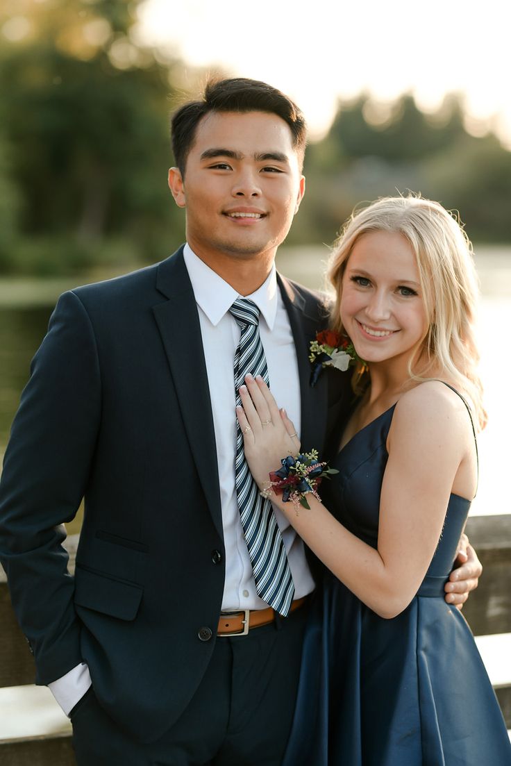 a young man and woman posing for a photo