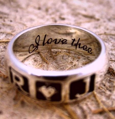 a wedding ring with the word lovethreae written in black and white lettering