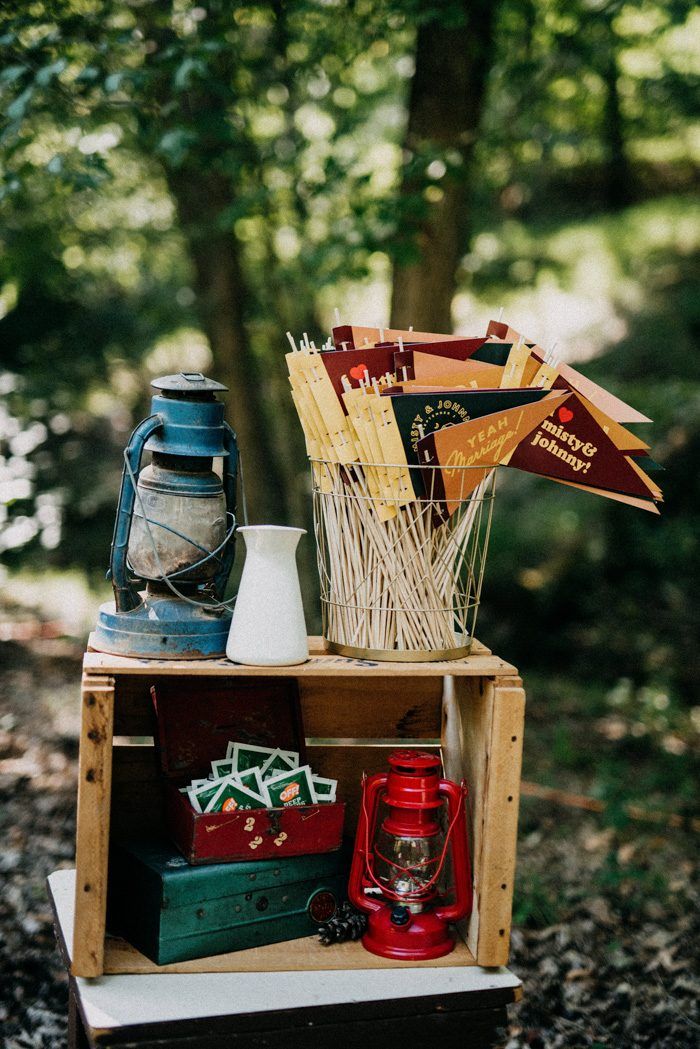 a wooden crate filled with assorted items in the woods