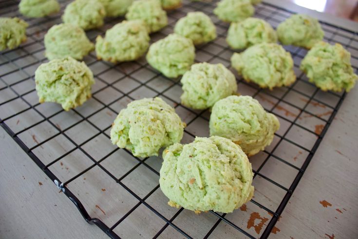 some cookies are cooling on a rack and ready to be baked in the oven for consumption