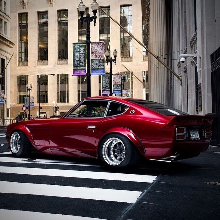 a red car is parked on the street