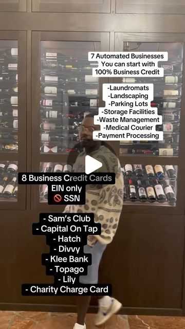 a man standing in front of a display case filled with wine bottles