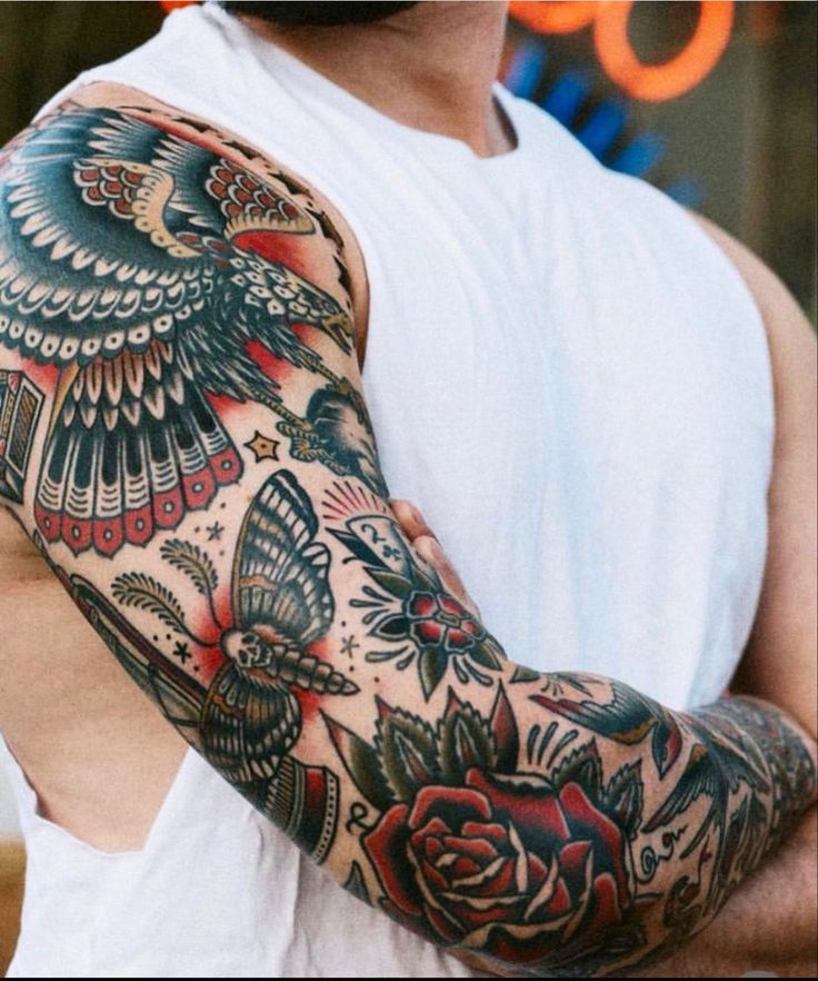 a man with tattoos on his arm and shoulder