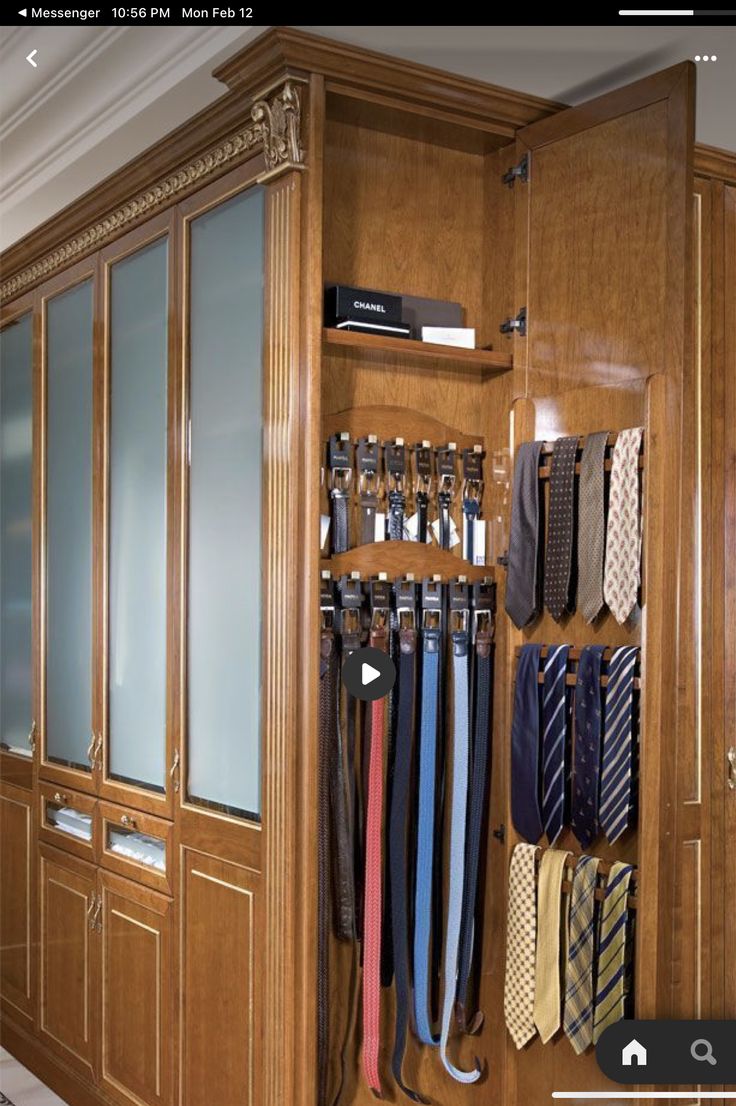 a closet with ties hanging on the wall