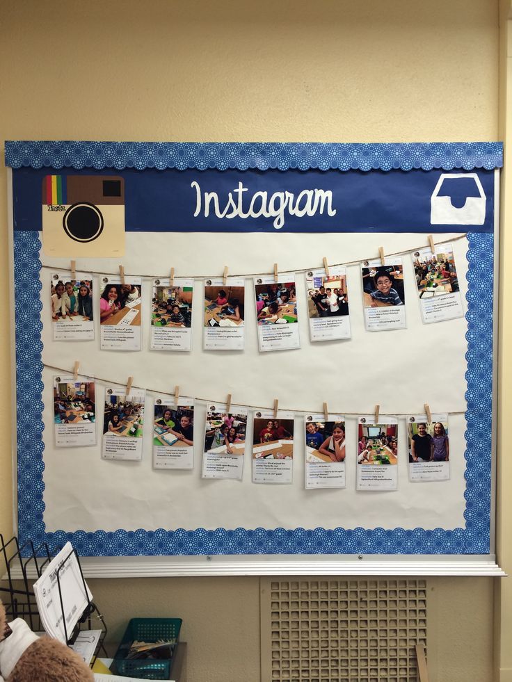 a bulletin board with pictures hanging on clothes pins