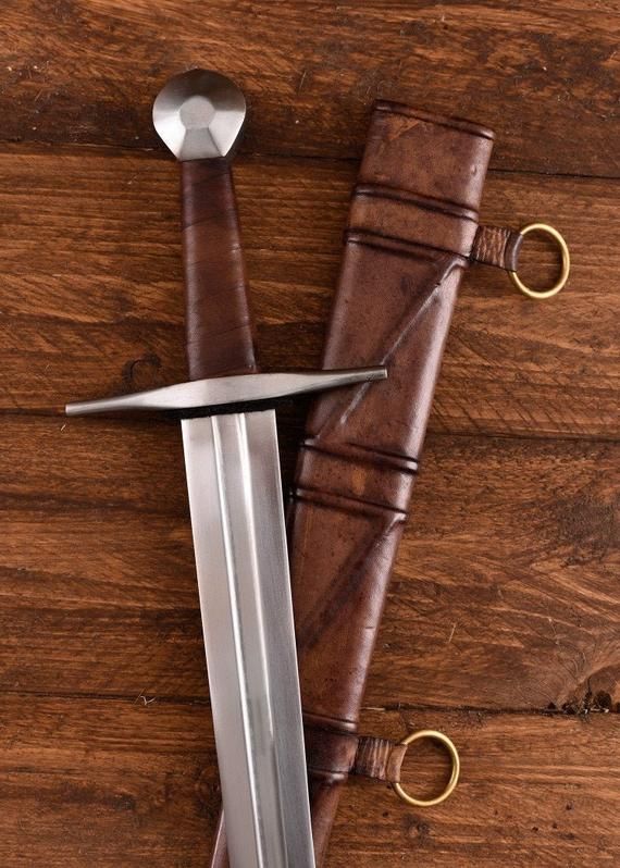 a knife and sheath on a wooden surface