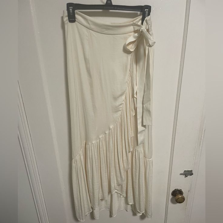 I Purchased This Silky Midi Skirt On A Recent Trip To Paris Only To Come Home And Realize It’s A Bit Small. Brand New Condition. Size 38 In France But A Size 6 Us. Has The Appearance Of A Wrap Skirt But Is Actually Closed Via A Zipper. Lined. Cream Ruffled Long Skirt, Cream Long Ruffled Skirt, White Elegant Maxi Skirt For Brunch, Elegant White Maxi Skirt For Brunch, White Fitted Maxi Skirt For Brunch, Cream Flowy Skirt For Brunch, Cream Asymmetrical Relaxed Skirt, White Asymmetrical Skirt For Brunch, White Chic Flowy Wrap Skirt