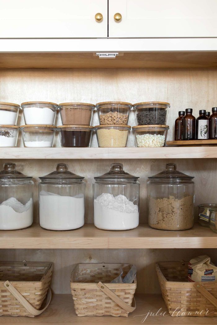 the shelves are filled with different types of food and storage containers, including cereals