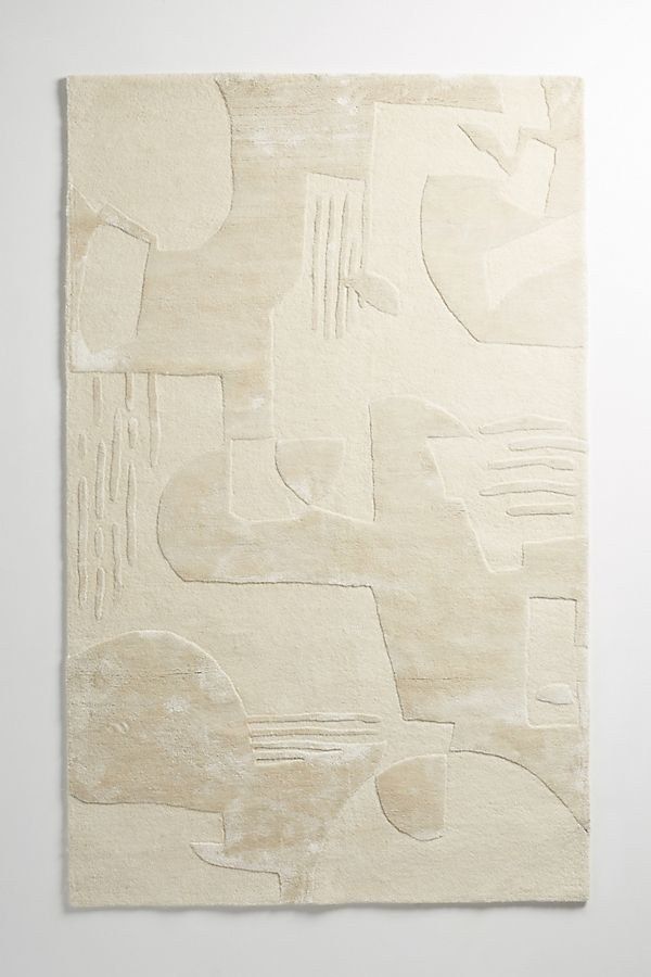 an abstract painting on the wall with white paint and shapes in neutral tones, including lines