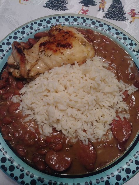 a blue plate topped with rice and meat covered in gravy on top of a table