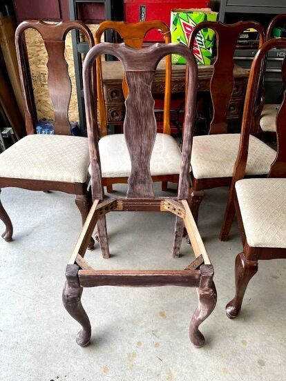 four wooden chairs sitting next to each other on top of a white carpeted floor