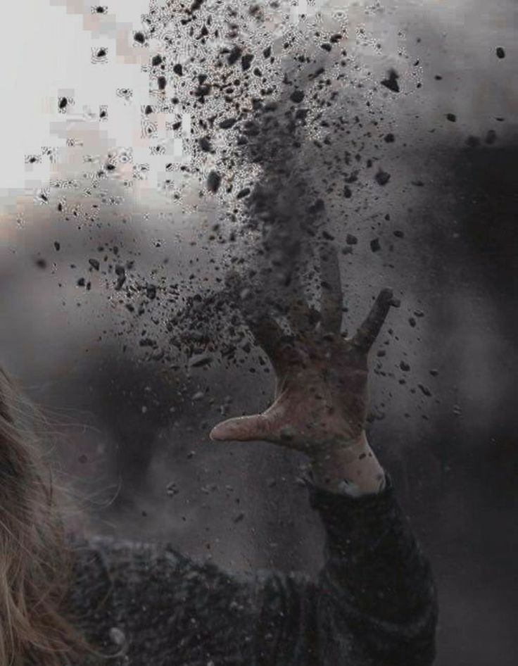 a woman holding her hand up in the air as she is covered with dirt and mud