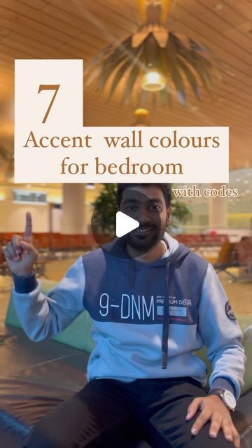 a man sitting on top of a couch in front of a ceiling fan with the words 7 accent wall colors for bedroom