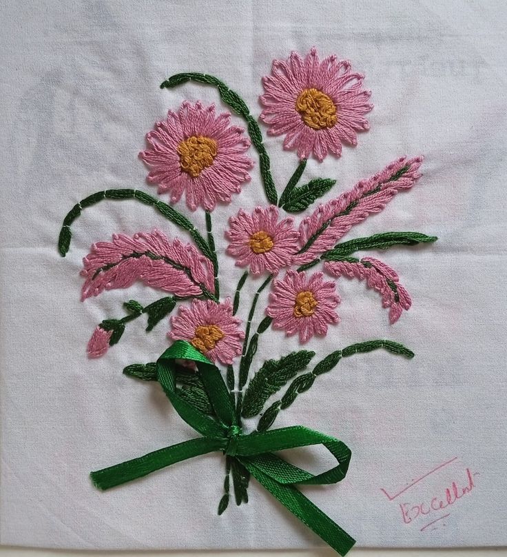 a bunch of pink flowers on a white cloth