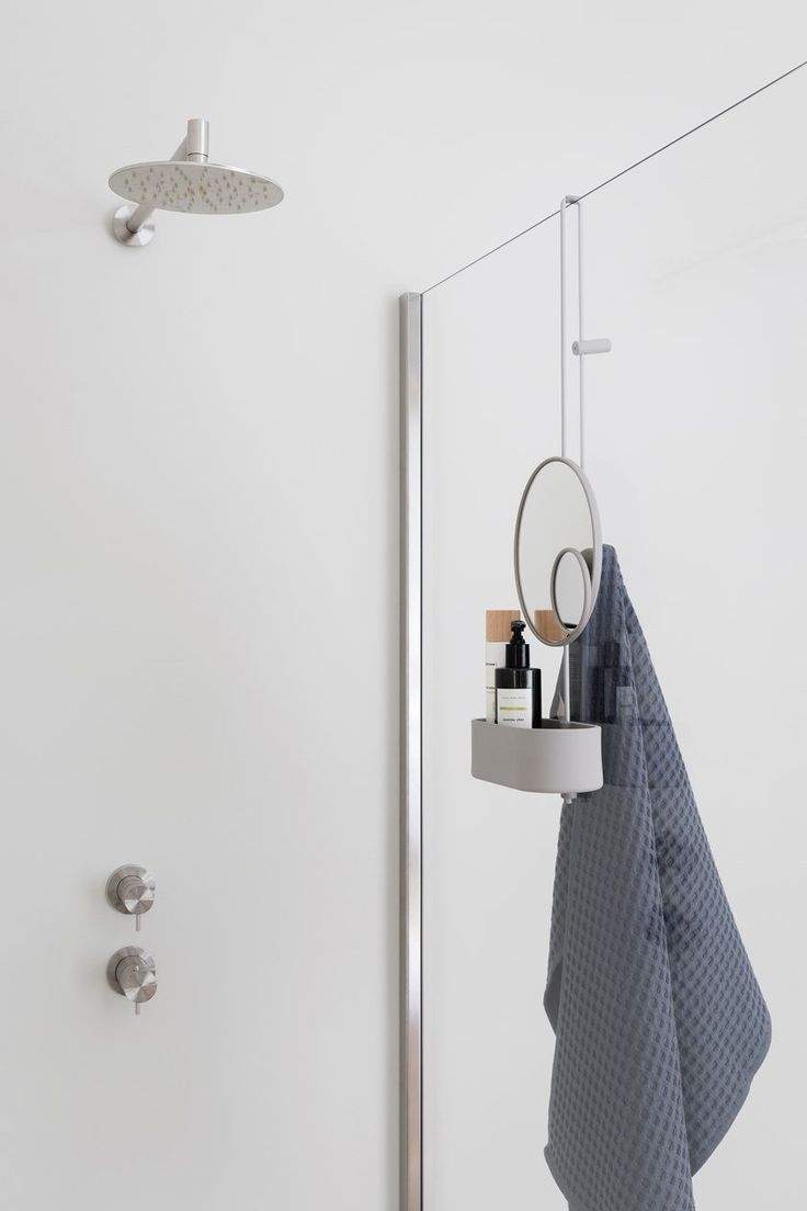 a towel rack is hanging on the wall next to a shower