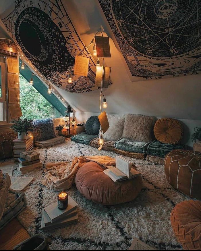 a living room filled with lots of furniture and decor on top of a carpeted floor