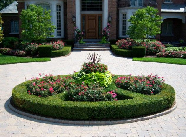 a house with a circular garden in the front yard