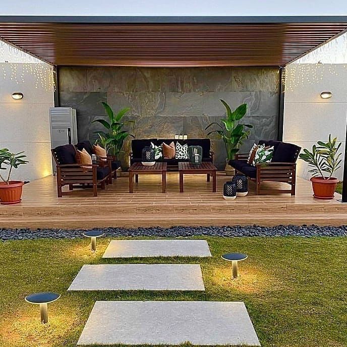 an outdoor living area with steps leading up to the patio