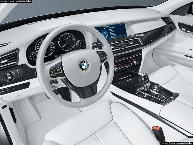 the interior of a white bmw car