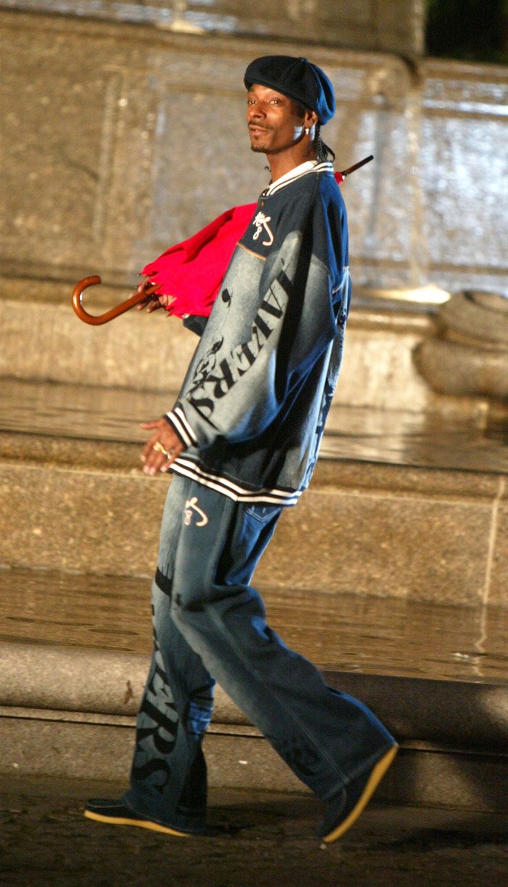 a man walking down the street with an umbrella