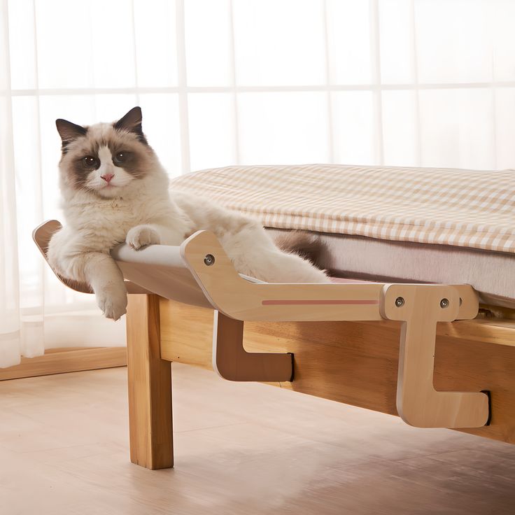 a cat laying on top of a wooden bed frame