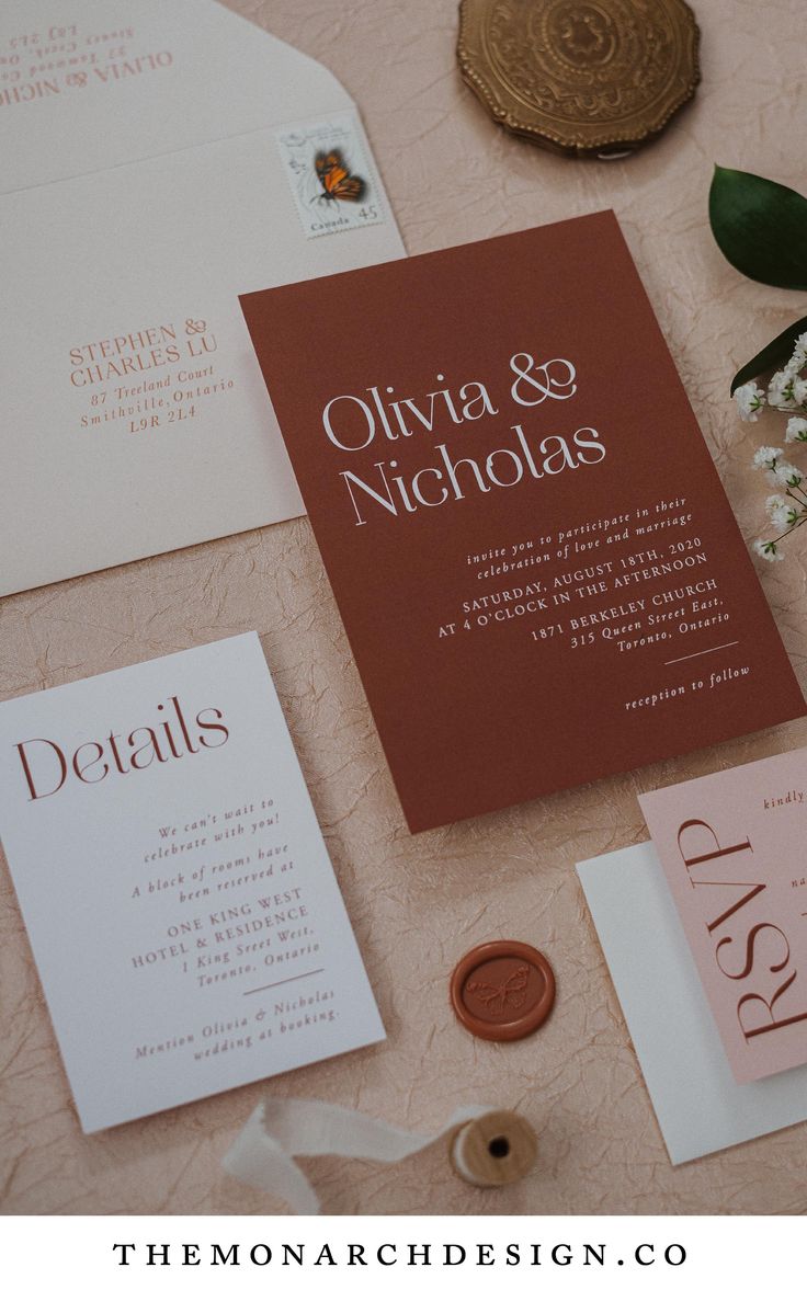 the wedding stationery is laid out on top of the table with flowers and other items