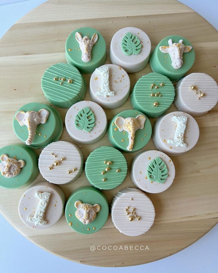 there are many different decorated cookies on the table together, including giraffes and elephants