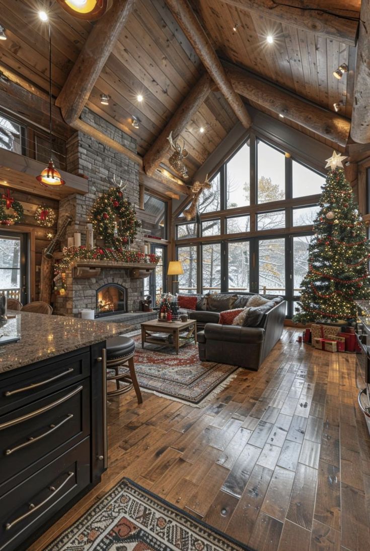 a living room filled with furniture and a christmas tree in the middle of it on top of a hard wood floor