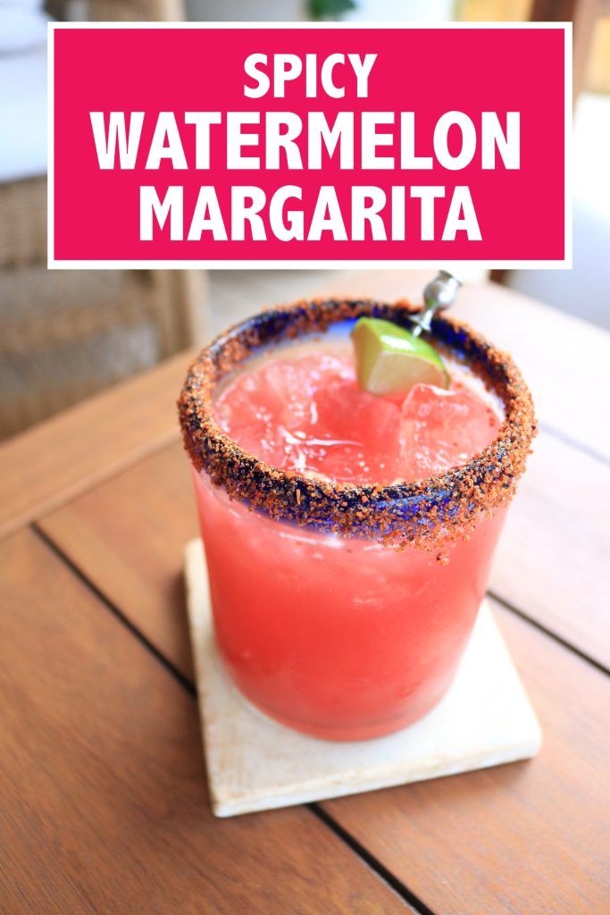 a red drink sitting on top of a wooden table