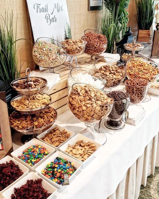 a buffet table filled with lots of different types of snacks and desserts on top of it