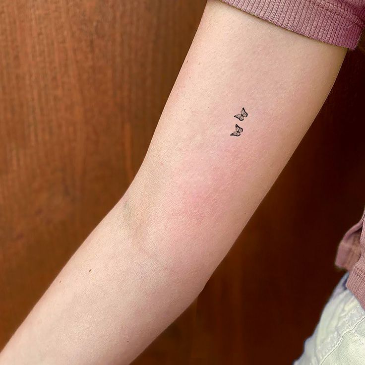 a person with a small tattoo on their arm