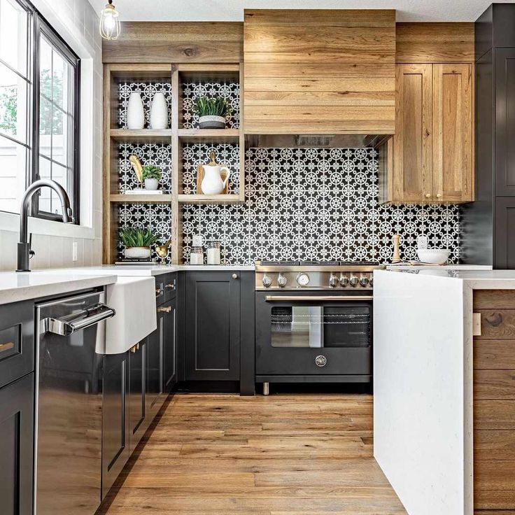 a kitchen with wooden cabinets and white counter tops, black appliances and wood flooring