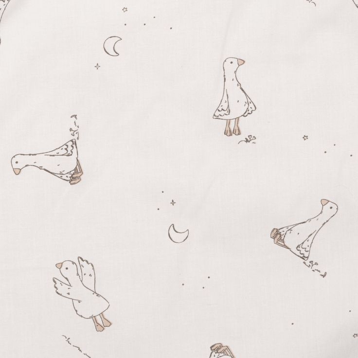 an image of a white fabric with birds and stars