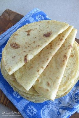 four tortillas sitting on top of a blue towel