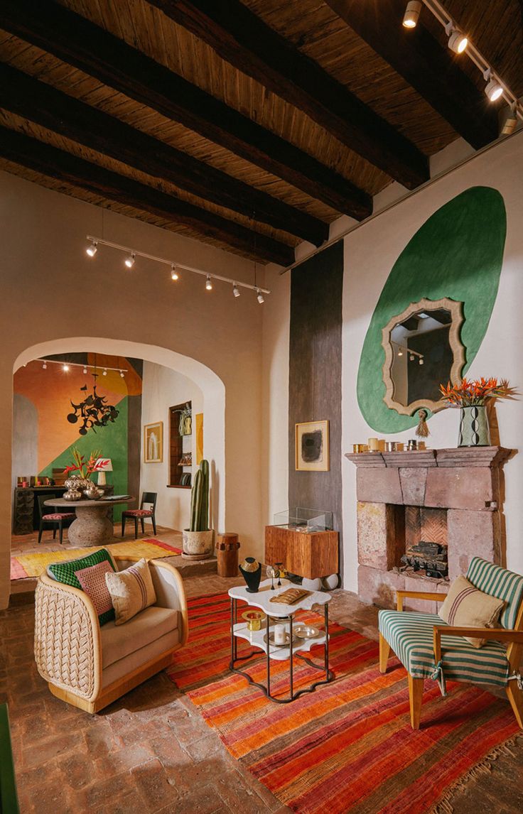 a living room filled with furniture and a fire place under a painting on the wall