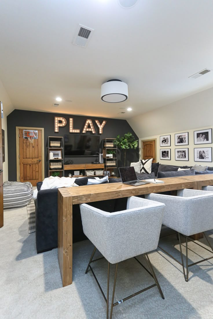 a living room filled with furniture and a wooden table topped with two white stools