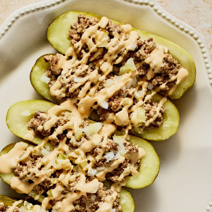 an image of stuffed green peppers with sauce on them and toppings in the middle